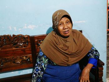 Portrait of senior woman sitting at home