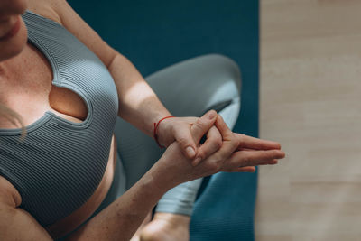 Midsection of woman holding hands