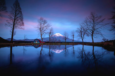 Scenic view of lake against sky at dusk