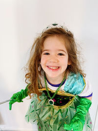 Portrait of smiling young woman against white background