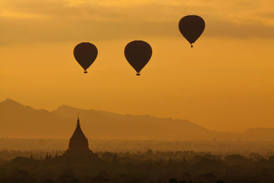 Hot air balloons against sky during sunset