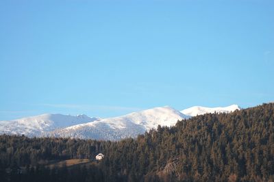 Scenic view of mountains against blue sky