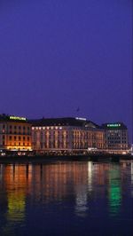 Illuminated buildings with waterfront at night