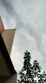 Low angle view of building against cloudy sky