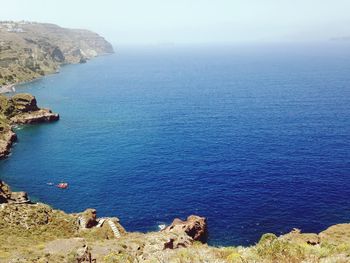 High angle view of sea and rocks against sky