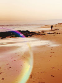 Scenic view of beach against sky during sunset