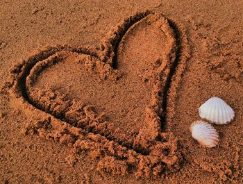 High angle view of heart shape on sand