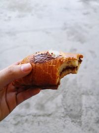 Close-up of hand holding pastry