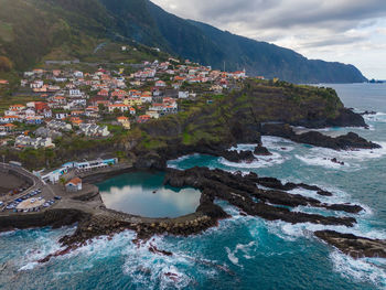 High angle view of townscape by sea