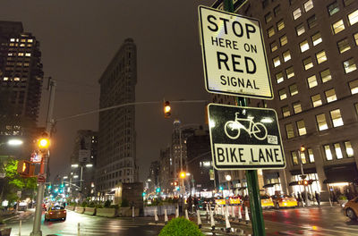 Illuminated city street and buildings at night