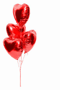 Close-up of heart shape balloon against white background