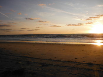 Scenic view of beach against sky during sunset