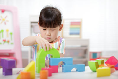 Close-up of boy playing with toy blocks