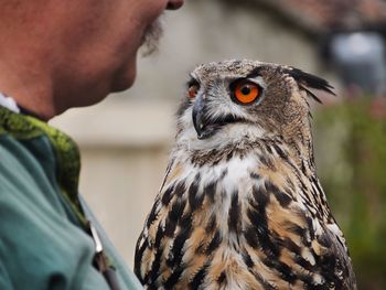 Midsection of man with owl outdoors