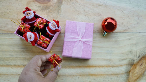 High angle view of person holding christmas decoration on table