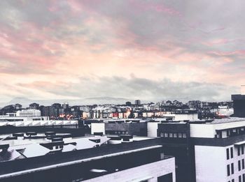 Buildings against cloudy sky