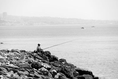 Lonely fisherman on the shore