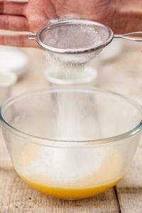 Close-up of hand pouring drink in glass