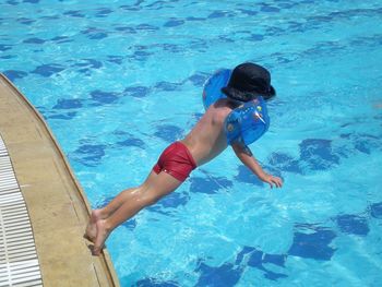 Rear view of diving into swimming pool