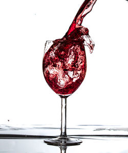 Close-up of wine glass against white background