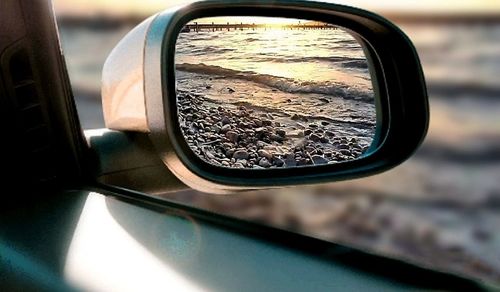 Reflection of side-view mirror of car