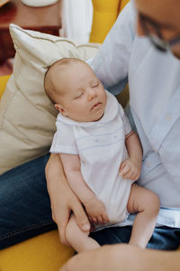 Close-up of baby boy sleeping on bed at home