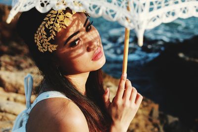 Close-up of thoughtful woman with umbrella