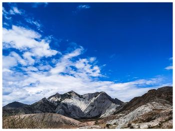 Scenic view of snowcapped mountain against blue sky