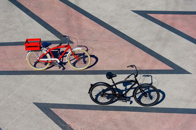 High angle view of bicycles parked on footpath