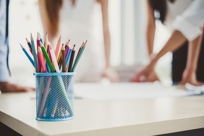 Close-up of colored pencils in desk organizer