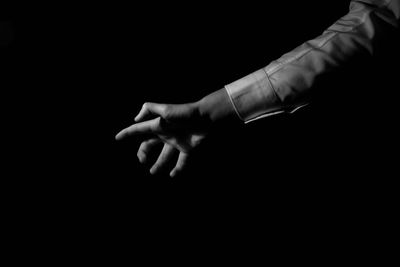 Aggressive mans finger against black background