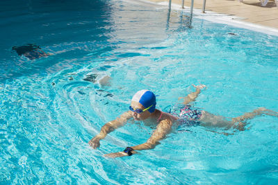 High angle view of people swimming in pool