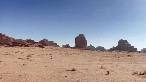 Rock formations on landscape against clear sky