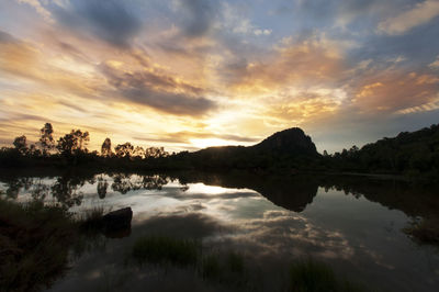 Scenic shot of calm lake at sunset