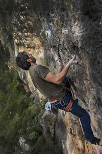 High angle view of man rock climbing