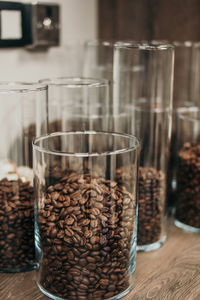 Close-up of coffee beans in glass on table