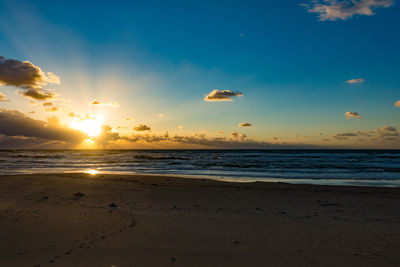 Scenic view of beach against sky during sunset