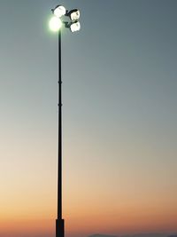 Low angle view of illuminated street light against clear sky