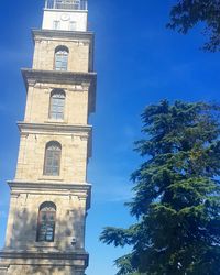 Low angle view of bell tower against blue sky