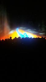 Silhouette landscape against sky at night