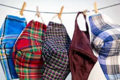 Close-up of multi colored umbrellas hanging in rack