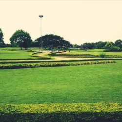 Scenic view of golf course against sky