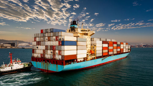 Container cargo ship carrying commercial container in import export business 