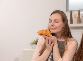 Portrait of young woman holding ice cream