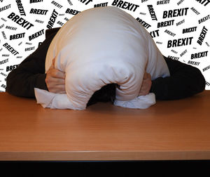 Midsection of man sleeping on table