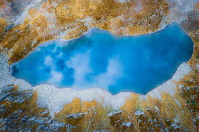 Aerial view of blue mountain lake with reflections of sky and clouds, austria 