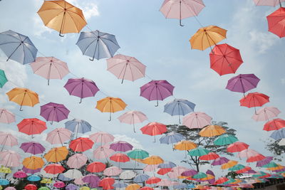 Low angle view of umbrellas against sky