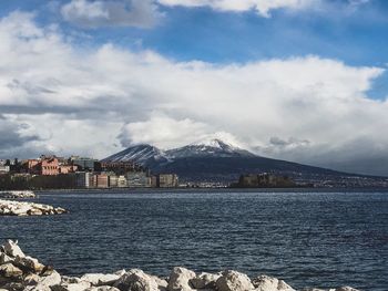 Scenic view of sea and mountains against sky