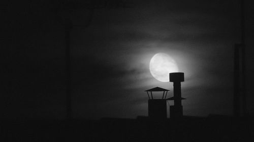 Low angle view of silhouette moon against sky at night