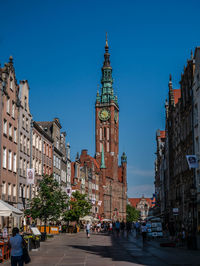 View of buildings in city against blue sky